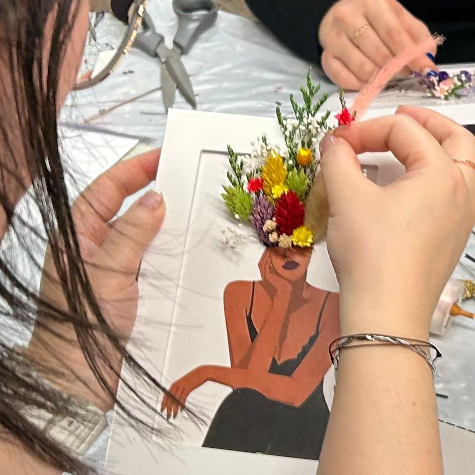 A BloomFrame: printed custom artwork with real preserved flowers pressed into the frame