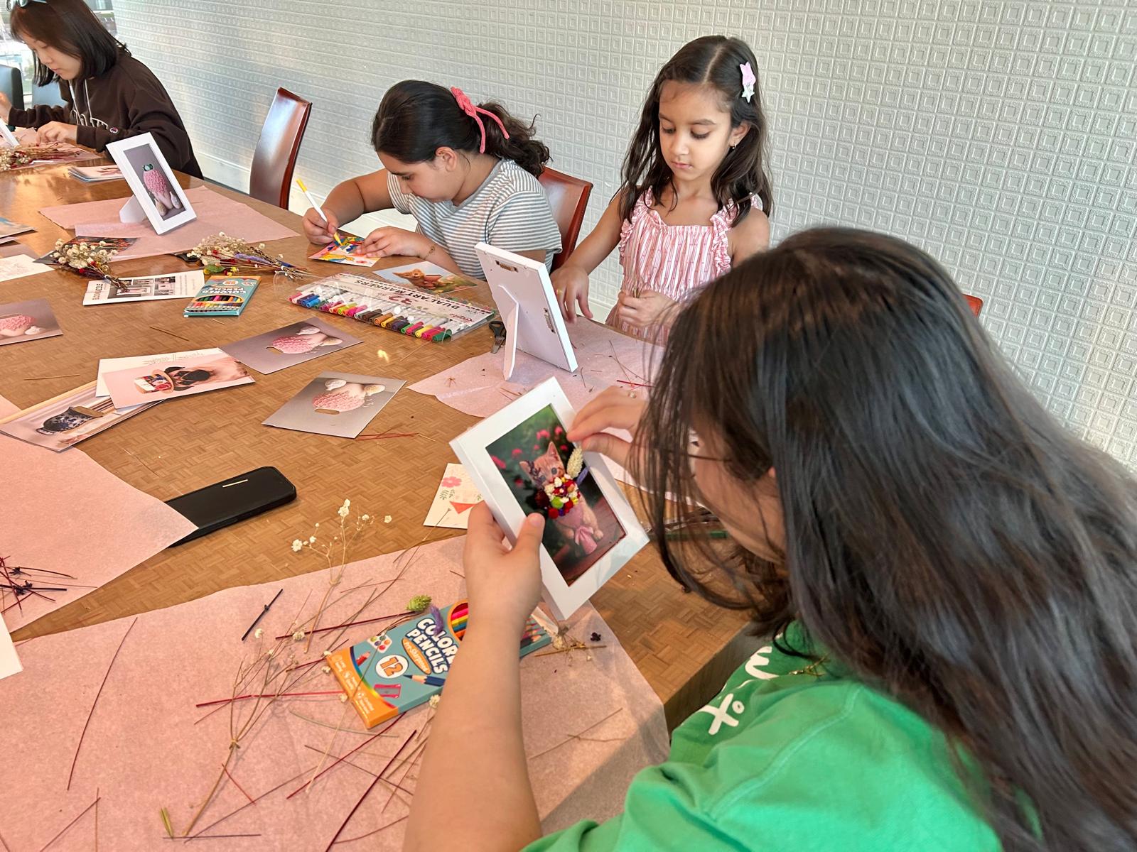 People making BloomFrames around a table
